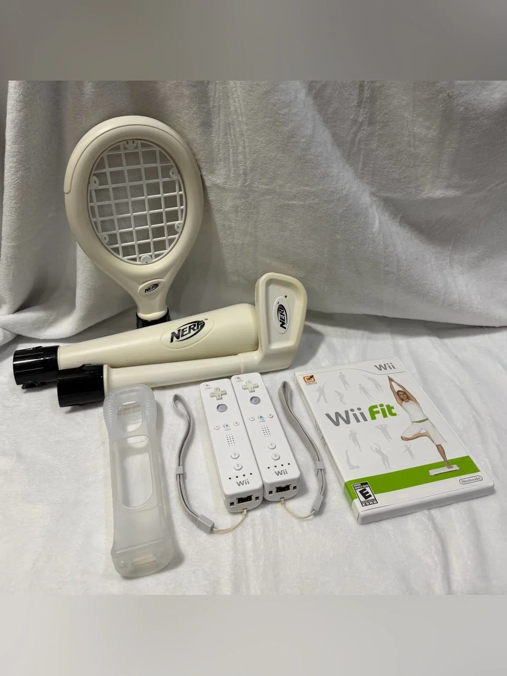 Nintendo Wii console with 2 remotes, 1 silicone sleeve & Nerf sports attachments